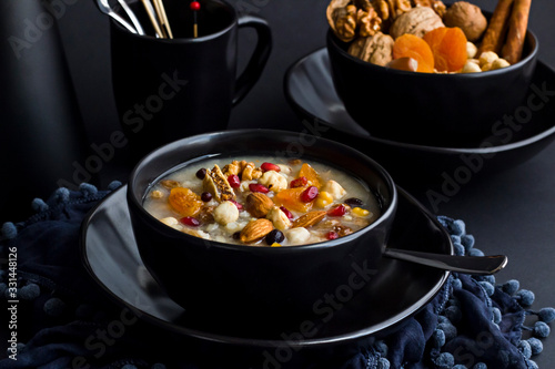 Traditional Dessert Asure,Noah Pudding in stylish,black color bowl on the black surface.Conceptual design.