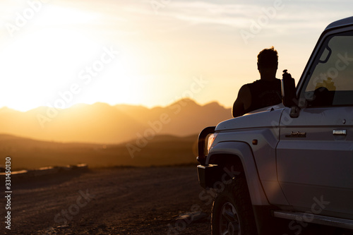 man and 4x4 sunset silhouette  photo