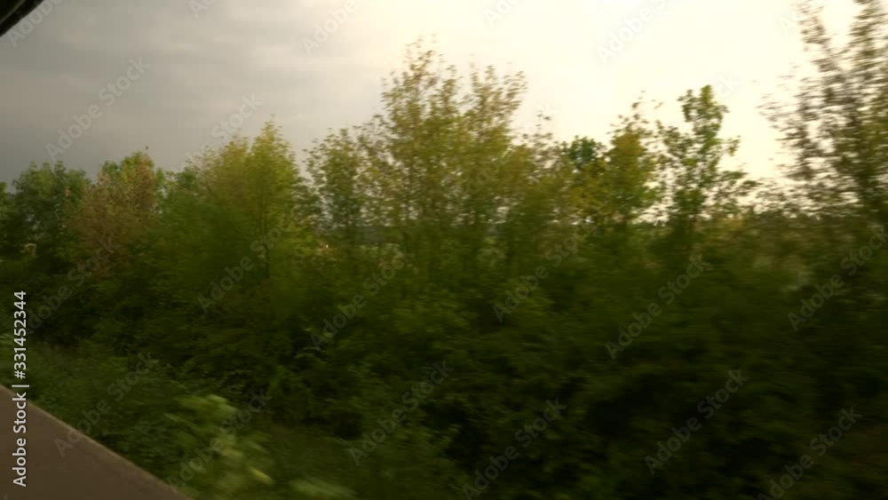 View From Train Car Wagon Opened Window. Traveling by Railway Across Europe. Trees Fields Village Evening Landscape. Summer Autumn Season, View From Train Car Wagon Opened Window. Traveling by Railway Across Europe. Trees Fields Village Evening Landscape. Summer Autumn Season,