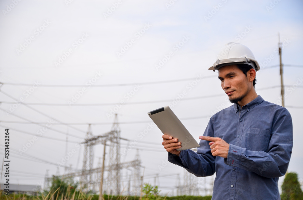 Electrical engineer holding and using a digital tablet