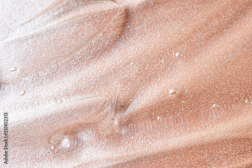 Transparent cosmetic antibacterial gel close-up. The concept of cleanliness. Antiseptic. Mother of pearl pink background.
