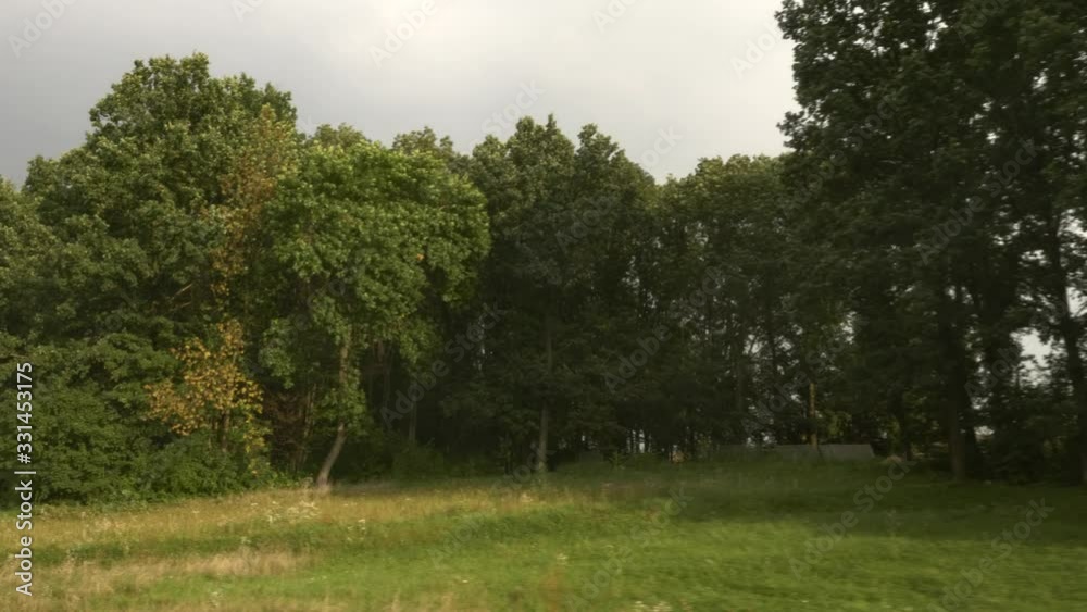 View From Train Car Wagon Opened Window. Traveling by Railway Across Europe. Trees Fields Village Evening Landscape. Summer Autumn Season, View From Train Car Wagon Opened Window. Traveling by Railway Across Europe. Trees Fields Village Evening Landscape. Summer Autumn Season,