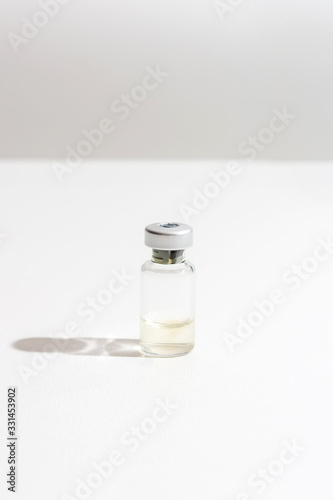 Liquid coronavirus COVID-19 vaccine is ready for use. Vertical format. Virus vaccine ampoule. Medicine and drug concept.