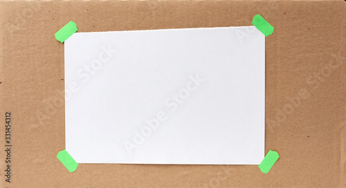 Bild auf Leinwand blank paper ad with torn edges attached with a green velcro on a brown cardboard
