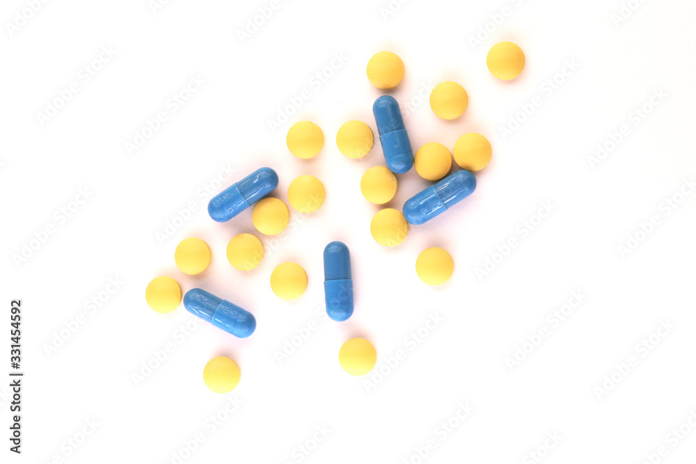 yellow and blue tablets on a white background yellow and blue tablets on a white background