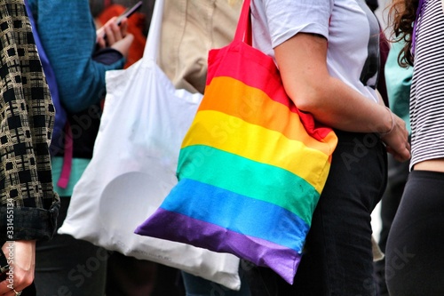 Woman carrying cloth bag in rainbow colors