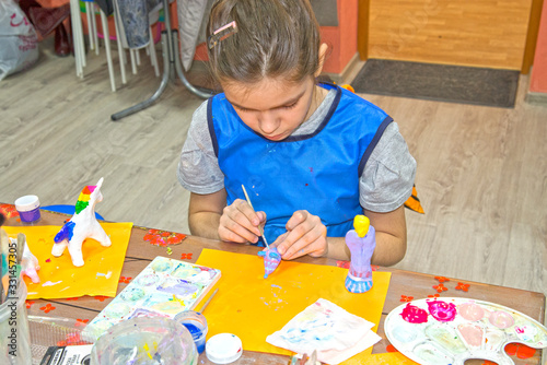 Passion and hobbies. Children do needlework, paint on clay figures
