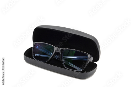 Stylish black glasses with blue tinted lens with black glasses case box isolated on white background.