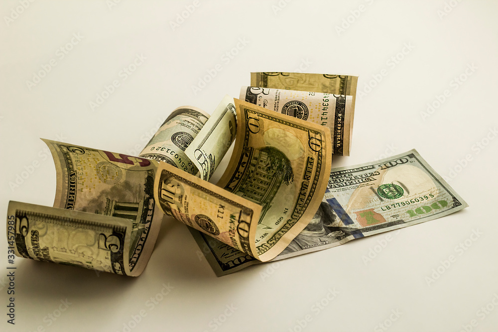 United State Dollars twisted on the white background with copy space