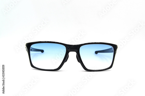 Stylish black glasses with blue tinted lens isolated on white background.