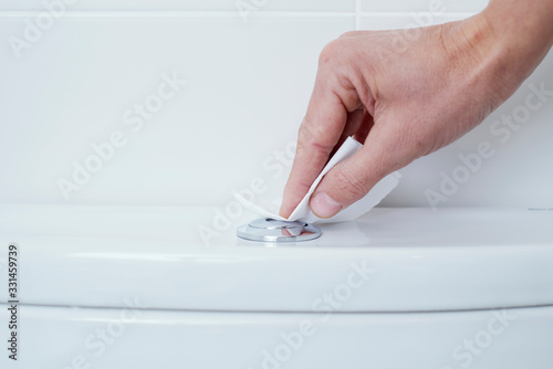 man flushing the toilet protected with paper
