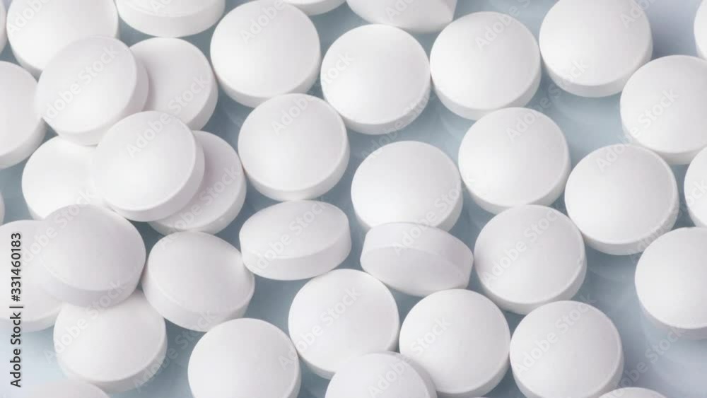 Closeup shot of different pills falling on table with tablets , pharmaceutical industry concept Closeup shot of different pills falling on table with tablets , pharmaceutical industry concept