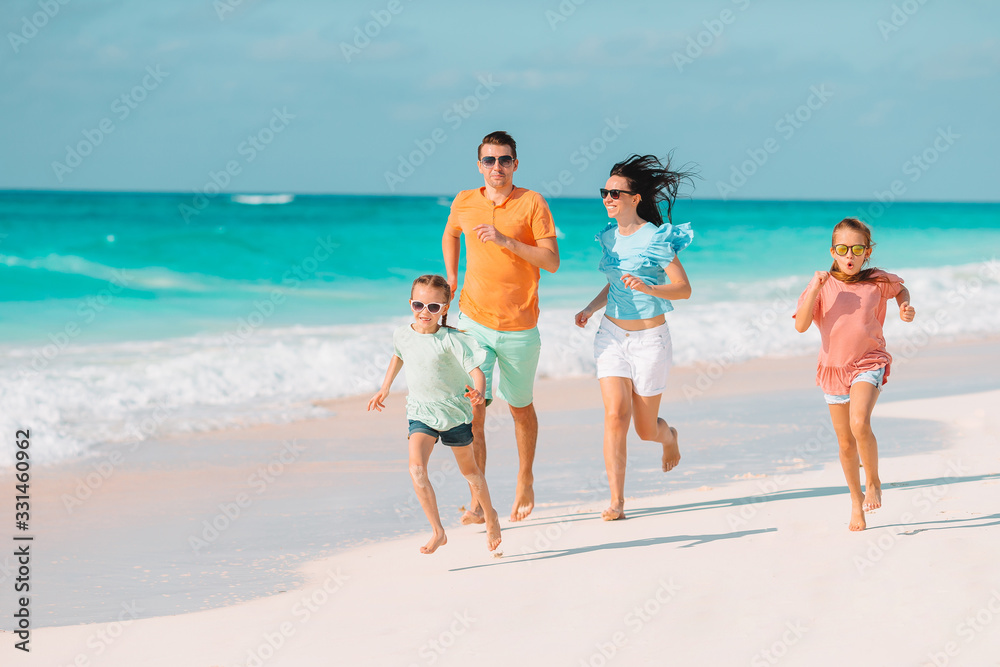 Happy family on the beach during summer vacation