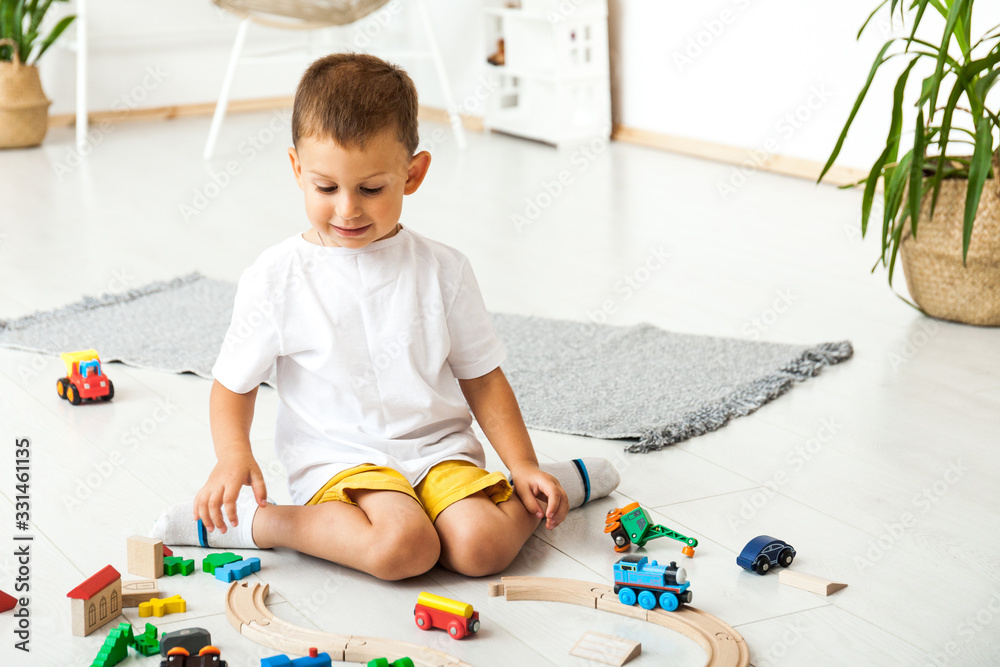 Boy playing with toys indoors at home Boy playing with toys indoors at home