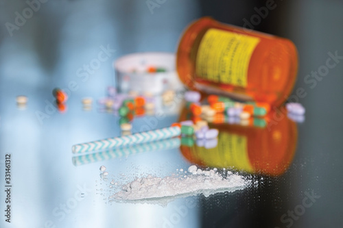 Spilled Pill bottle with controlled substances and anti-depressants and a line of powder and straw