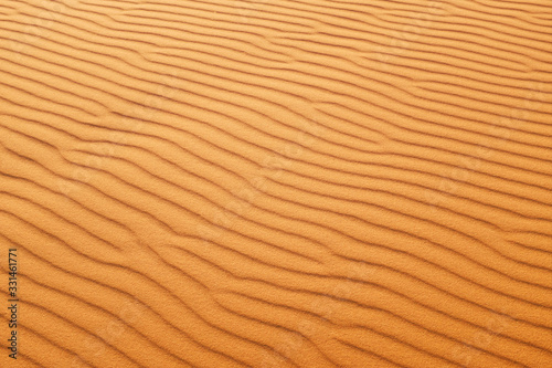 Desert sand patterns in rich orange color for a hot summer background.