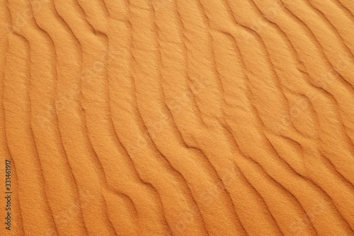 Bright orange desert sand ripples for a hot summer background.