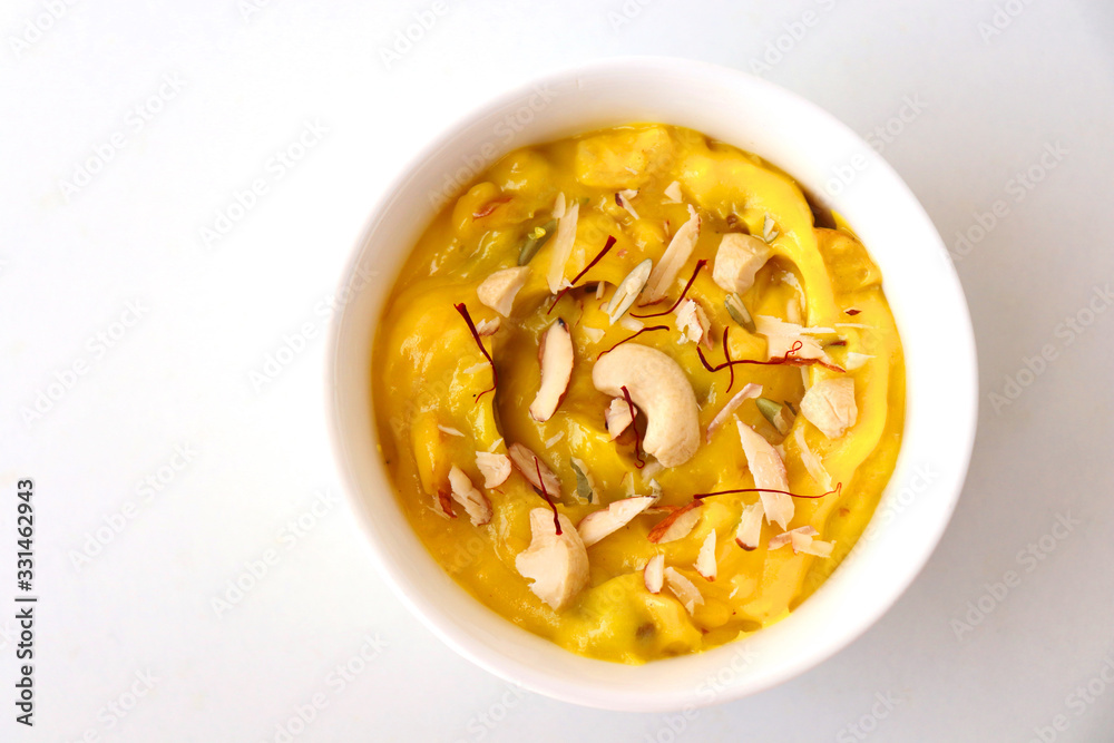 Indian dessert - Shrikhand or Srikhand is sweet yogurt dessert. Mostly eaten during Gudi Padwa festival with Puris. Garnished with dry fruits and saffron. Along with Happy Gudi Padwa message Greeting. Indian dessert - Shrikhand or Srikhand is sweet yogurt dessert. Mostly eaten during Gudi Padwa festival with Puris. Garnished with dry fruits and saffron. Along with Happy Gudi Padwa message Greeting.
