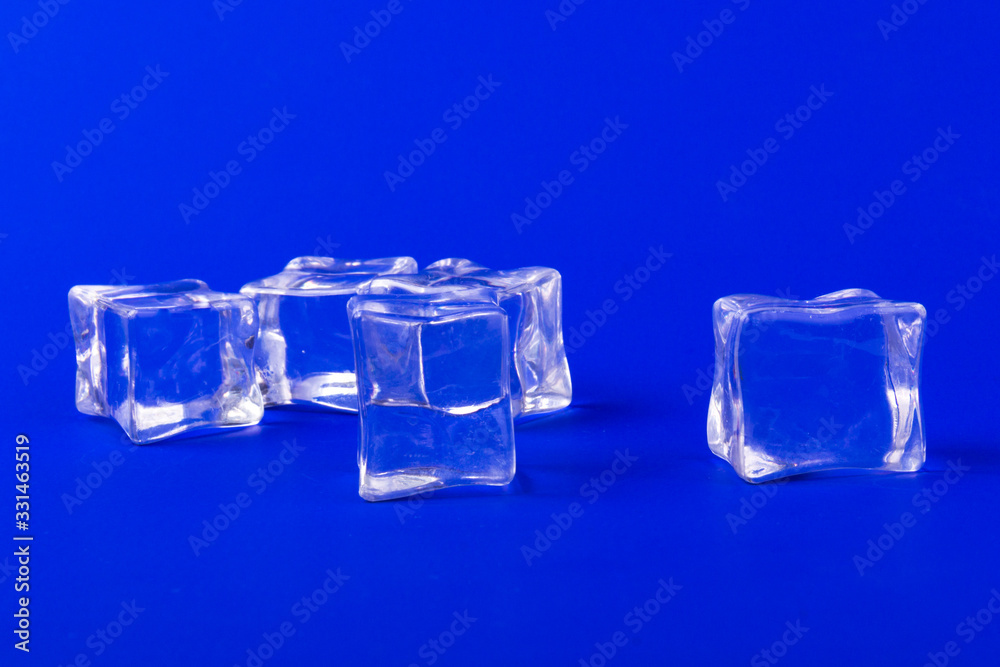 ice cubes in close-up on blue background ice cubes in close-up on blue background