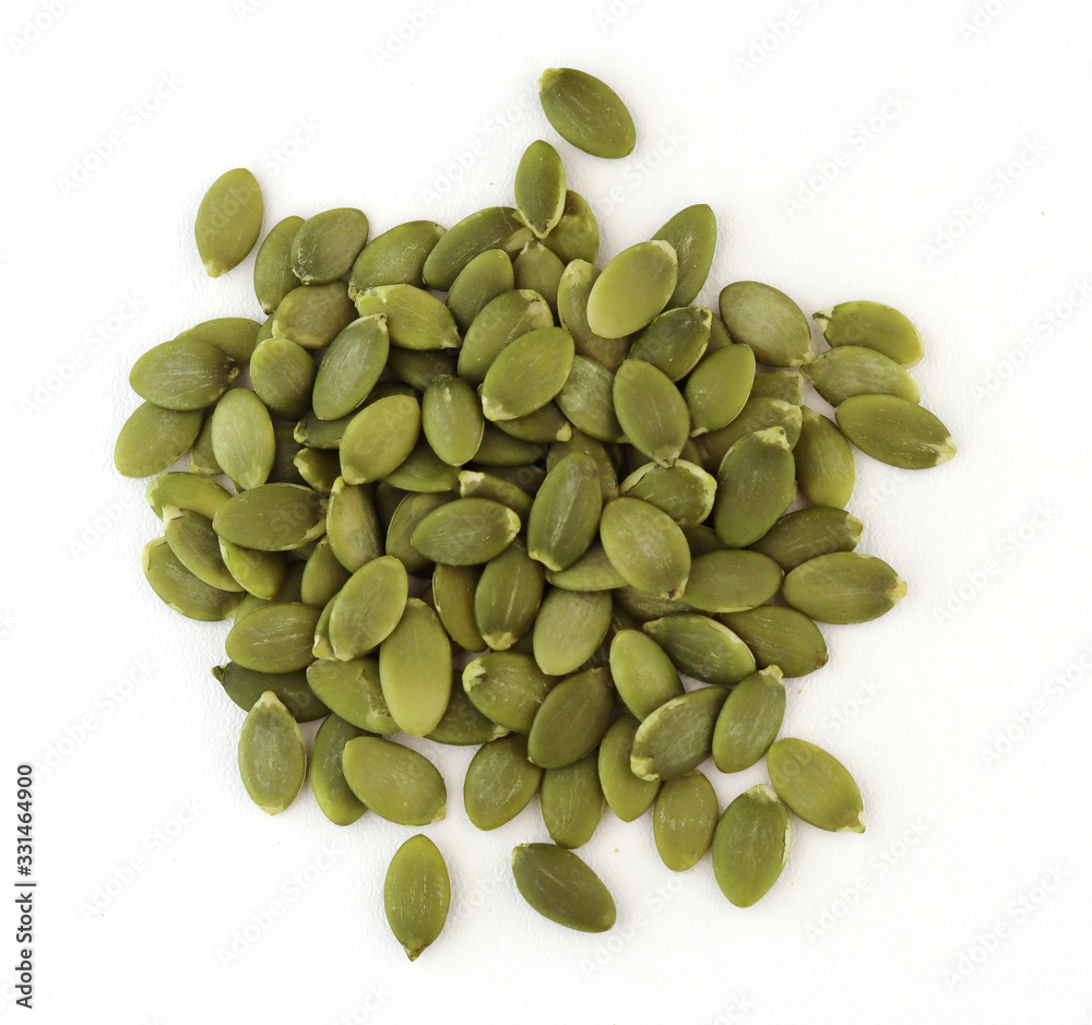 green pumpkin seeds on a white background