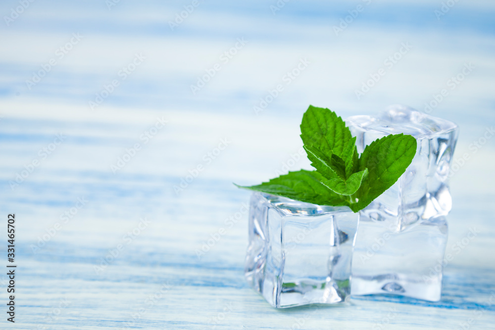 Ice and mint on a wooden table. Ice and mint on a wooden table.