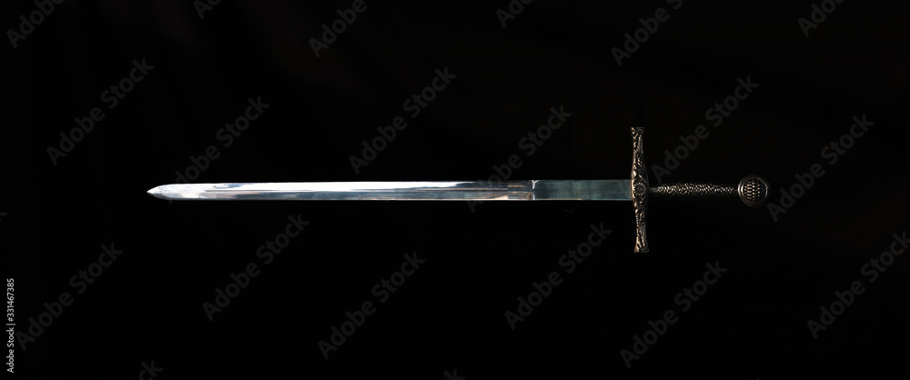 medieval knight's sword on a black background - obrazy, fototapety, plakaty 