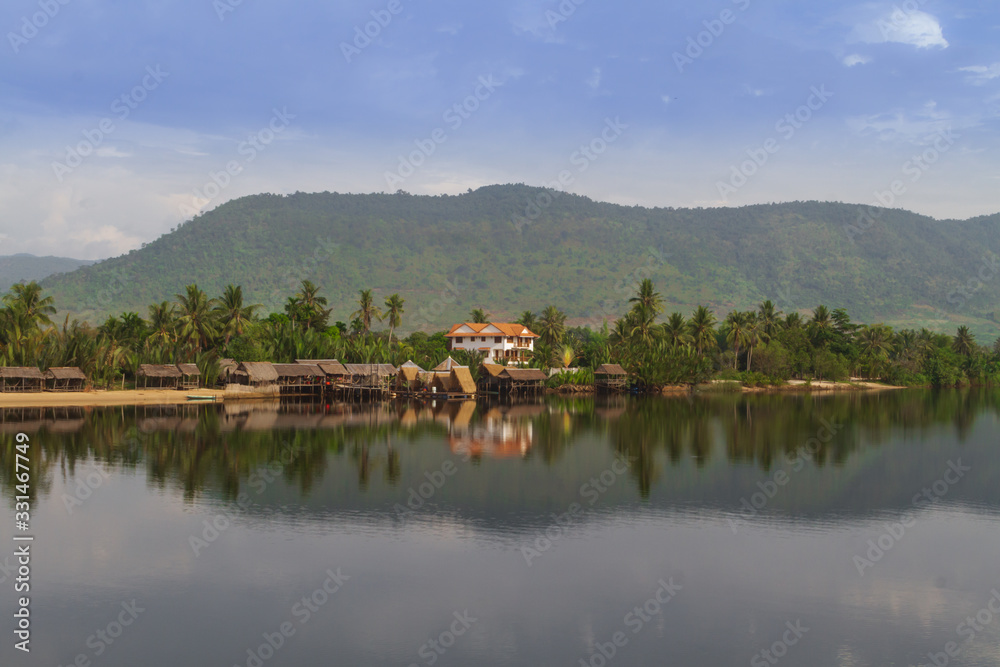 Mirror image of jungle house by the Preaek Tuek Chhuk River in Kampot