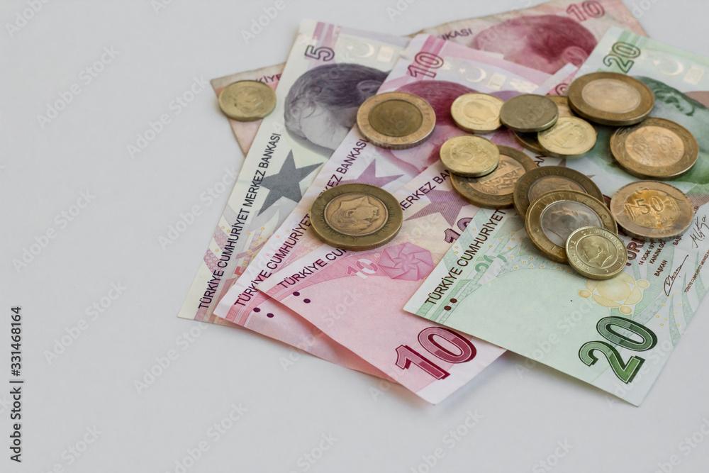 Turkish money twenty,ten and five lira banknotes on the white surface with coins and copy space Turkish money twenty,ten and five lira banknotes on the white surface with coins and copy space