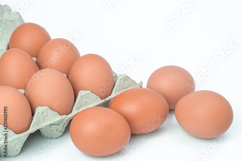 Chicken eggs in box on white background