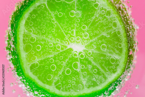 lime fruits in water under water with bubbles. juicy citrus close-up, macro. selective focus.