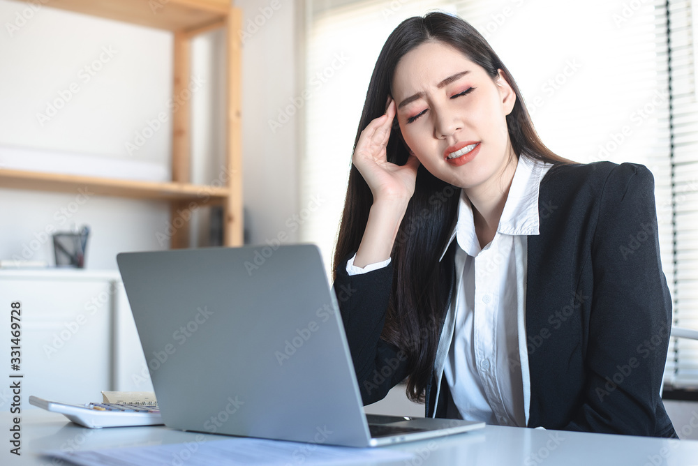 Asian woman office staff have headache, migraine while working. Healthy, Office syndrome, disease, illness, sick, muscle pain, overwork, neck ache, arthritis concept. Asian woman office staff have headache, migraine while working. Healthy, Office syndrome, disease, illness, sick, muscle pain, overwork, neck ache, arthritis concept.