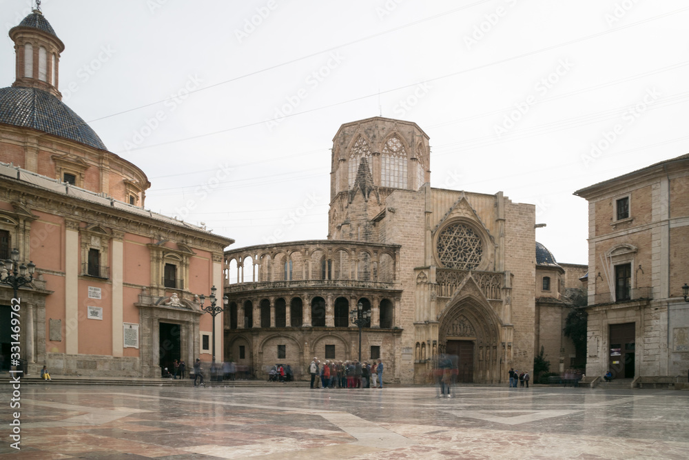 Valencia, Spain - February 12, 2020: View of the plaza de la virgen with the Basilica of the Virgen de los Desamparados and the cathedral