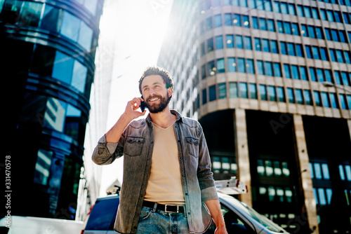 Businessman calling on smartphone at modern downtown