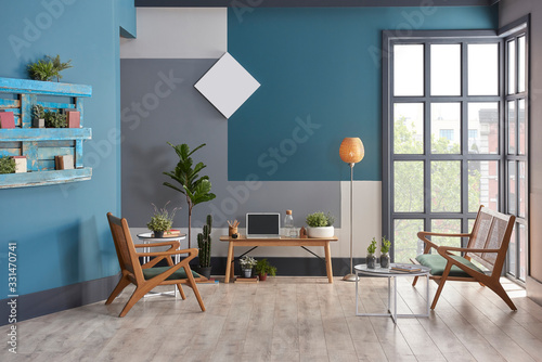 Decorative living room blue grey and white wall concept with black window. Wooden chair and furniture decor. lamp clock and carpet design. photo