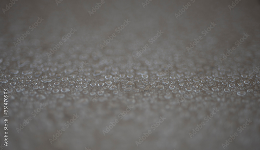 A lot of water droplets on a light brown background A lot of water droplets on a light brown background