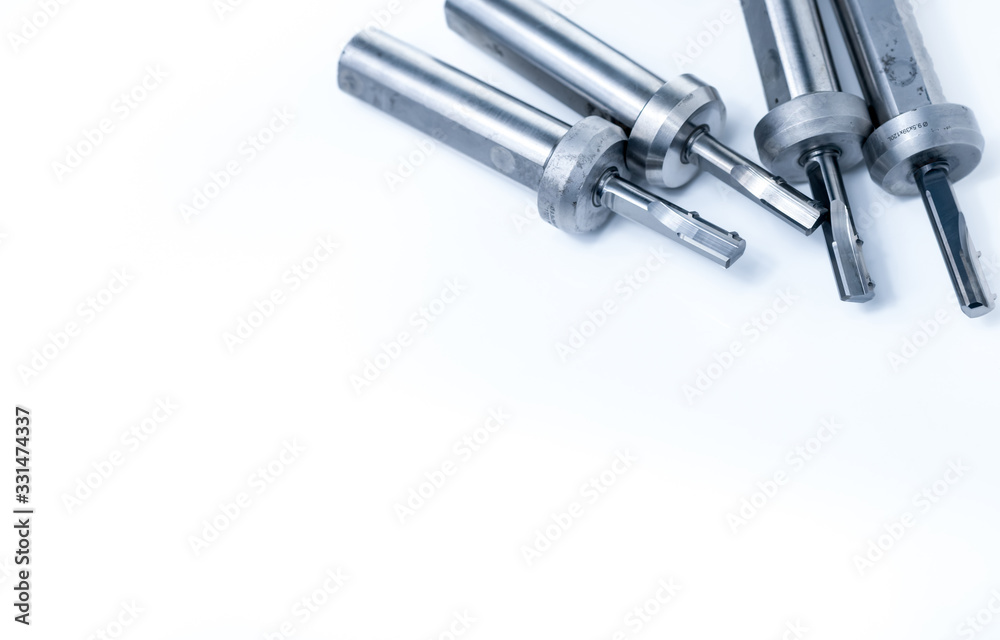 Set of special tools on white background. Made to order special tools. Closeup detail tip of reamer. HSS cemented carbide. Carbide cutting tool for industrial applications. Industry special tools. Set of special tools on white background. Made to order special tools. Closeup detail tip of reamer. HSS cemented carbide. Carbide cutting tool for industrial applications. Industry special tools.