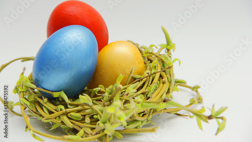 colorful Easter eggs in a nest of young willow branches