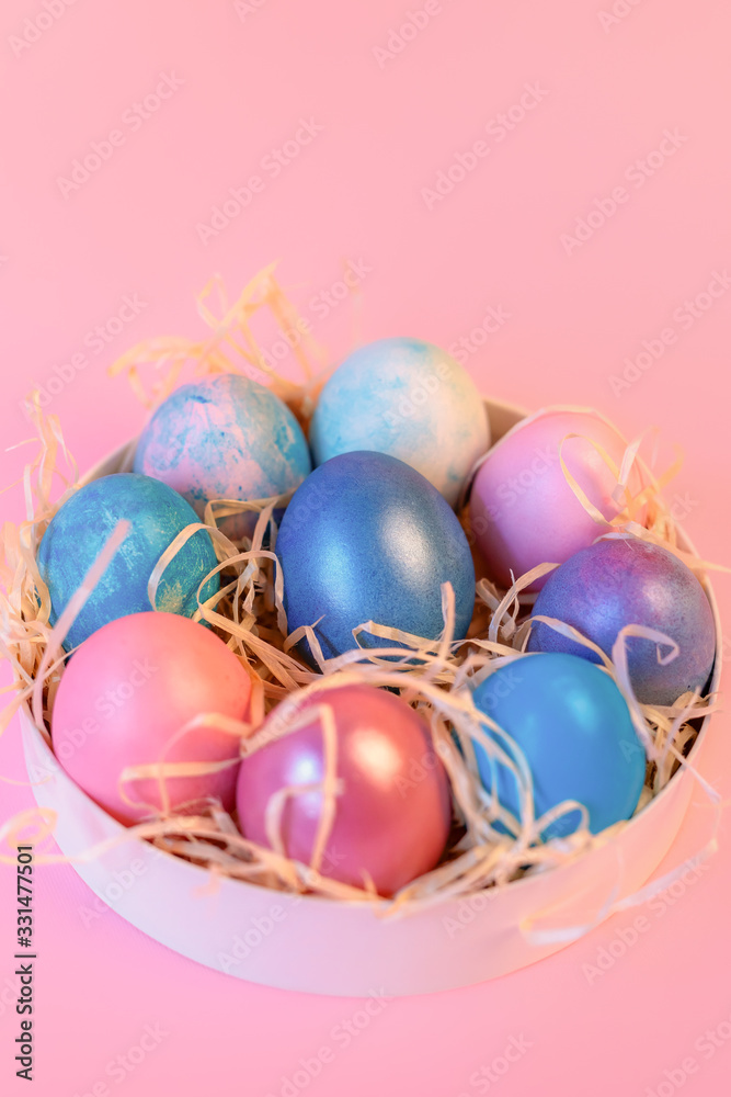 Still life with easter decorated eggs in a box on a pink background. Still life with easter decorated eggs in a box on a pink background.