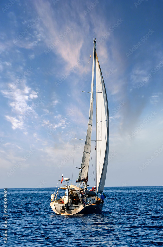 Fototapeta premium close-up sailboat sailing under a beautiful sunset