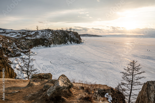 Winter sunset landscape of lake Baikal on Olkhon island. Mountains of snow and ice. Unique nature in Russia