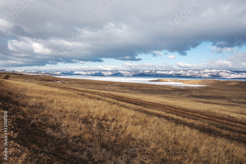 Winter sunset landscape of lake Baikal on Olkhon island. Mountains of snow and ice. Unique nature in Russia © Artem