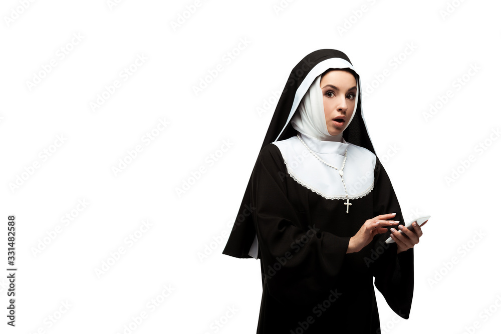 beautiful shocked nun using smartphone isolated on white beautiful shocked nun using smartphone isolated on white
