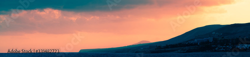  Panorama of Golden Sunset Over The Mountains Silhouette Of A Mountain Range Against The Sky At Sunset © luchschenF