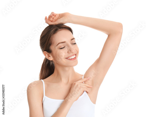 Young woman showing armpit with smooth clean skin on white background photo