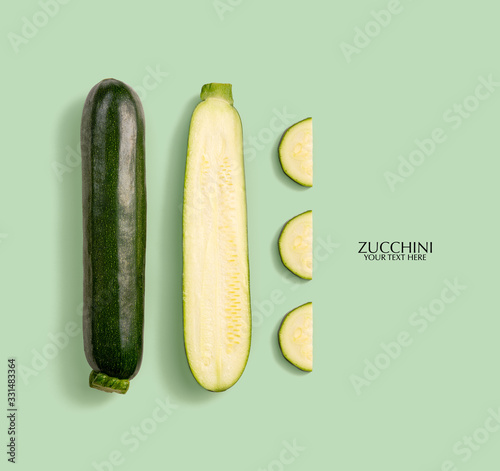 Creative layout made of green zucchini. Flat lay with copy space. Fresh food concept. Zucchini isolated on white background.