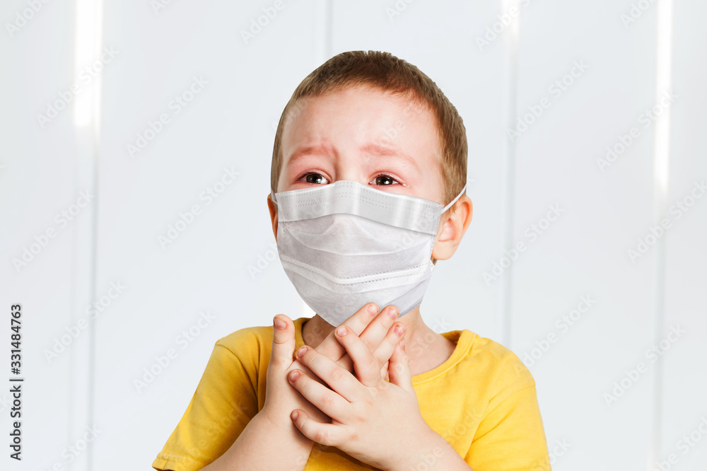 worried child wearing a protective face mask to prevent virus infection or pollution