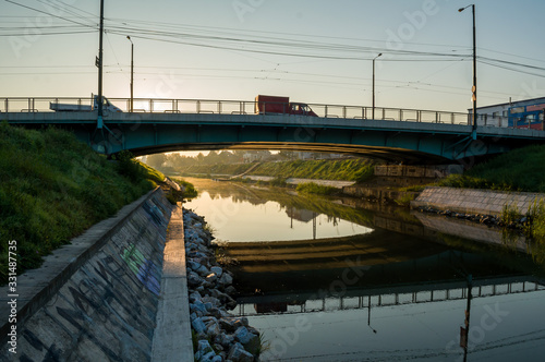 A view of the Bega river early in the morning. Sunrise in the city. Mihai Viteazul bridge. photo