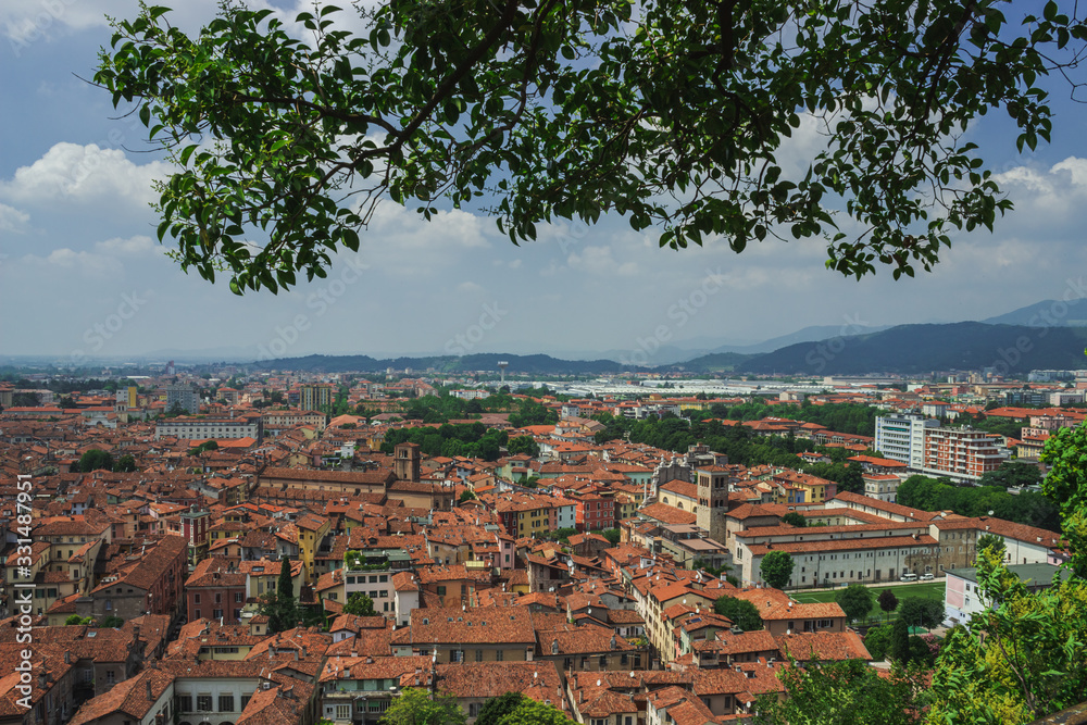 View of the tiled roofs of Brescia in the haze of a hot day. Soft focus, blurry background.