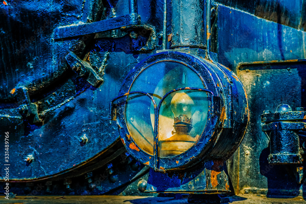 Headlight of a vintage steam locomotive of a pre-electricity age. Household oil lamp is used inside the headlight. History of the railroad transport.