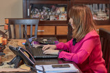 woman working from home with the computer voip phone and mobile